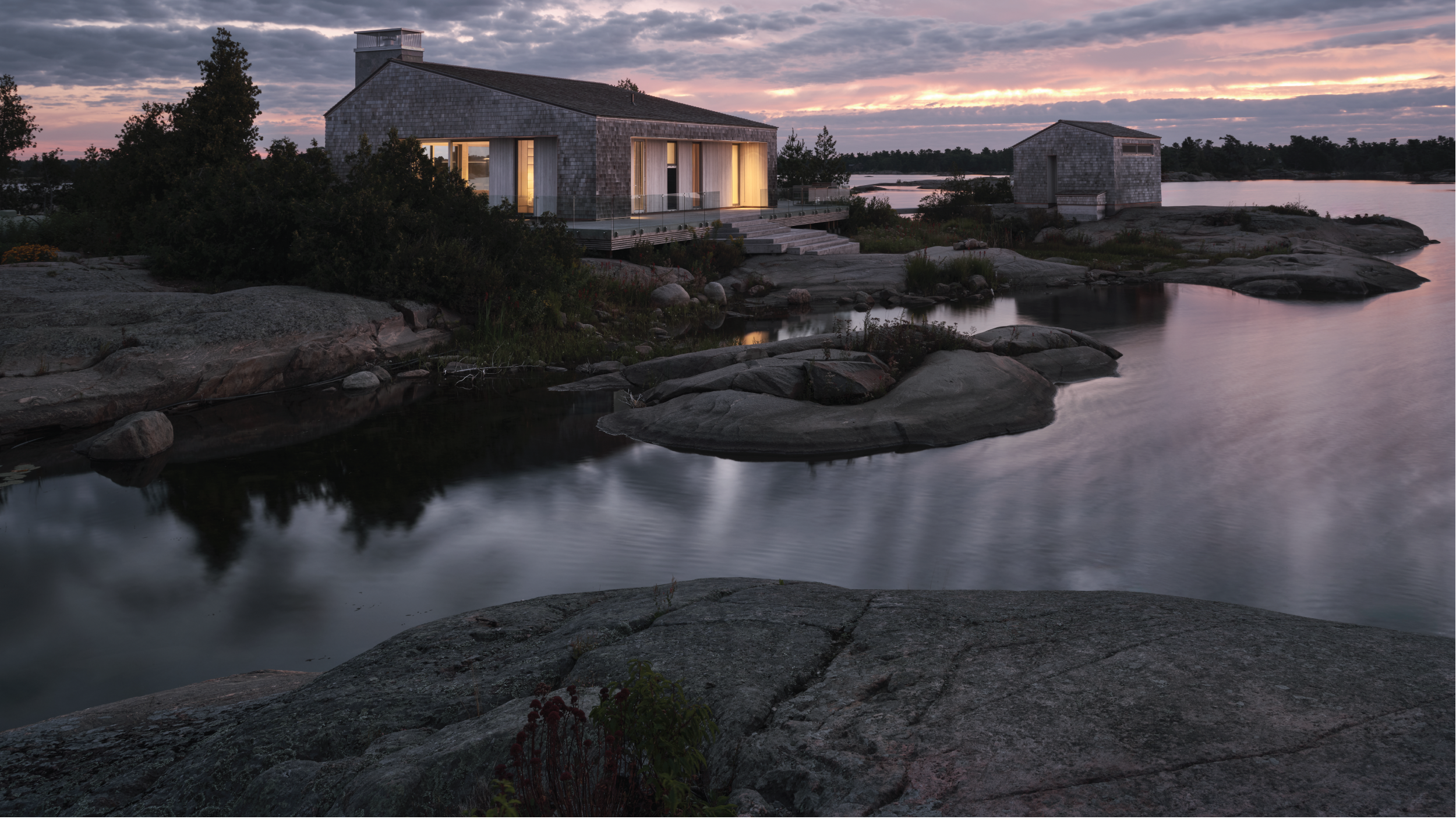 exterior image of whistling wind island cottage as the sun sets