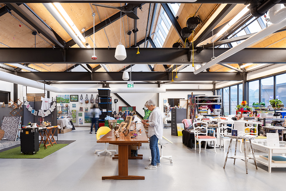 a well-lit interior artist workshop with a sawtooth roof and clerestory windows