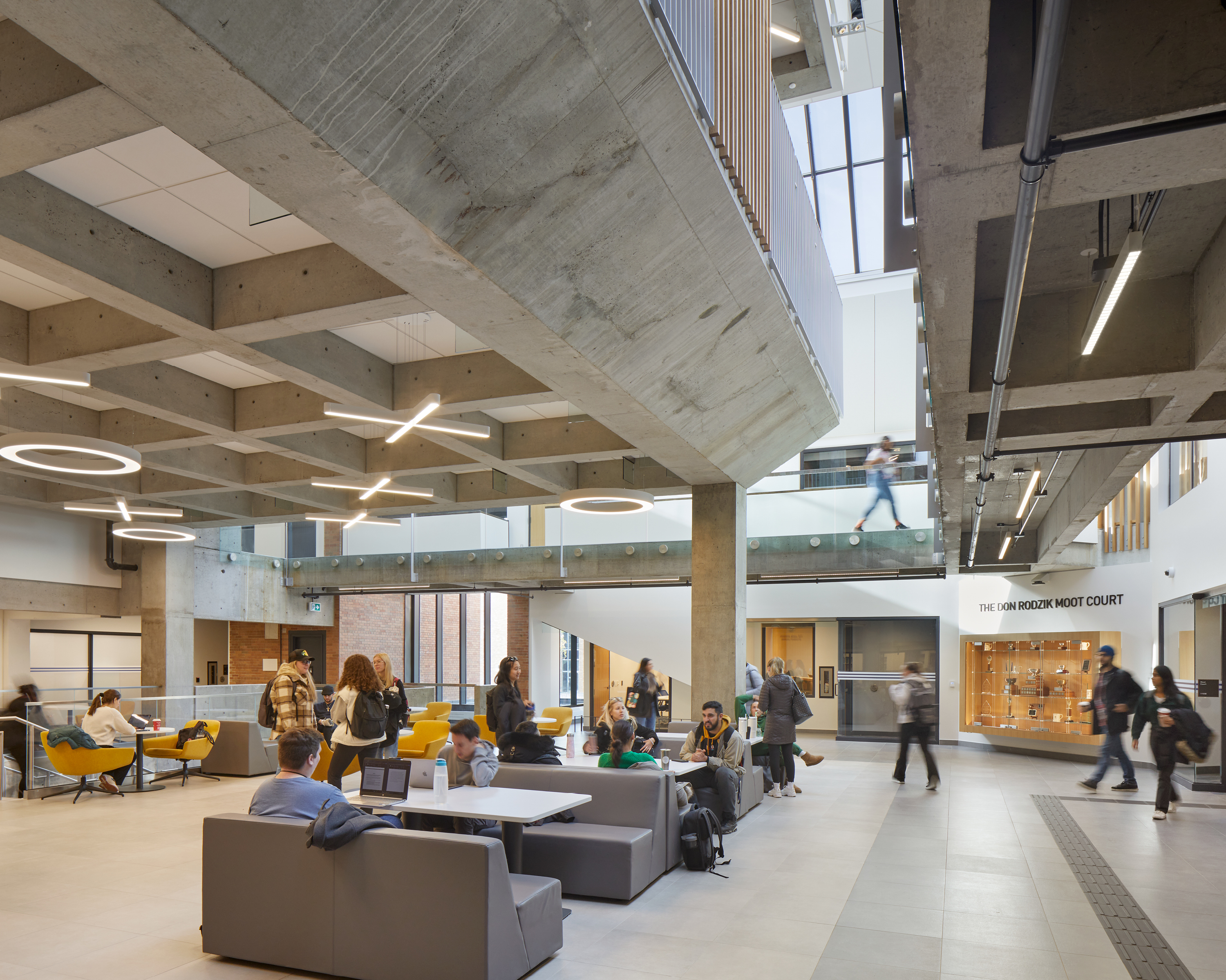 A spacious interior of an academic building with exposed concrete structure