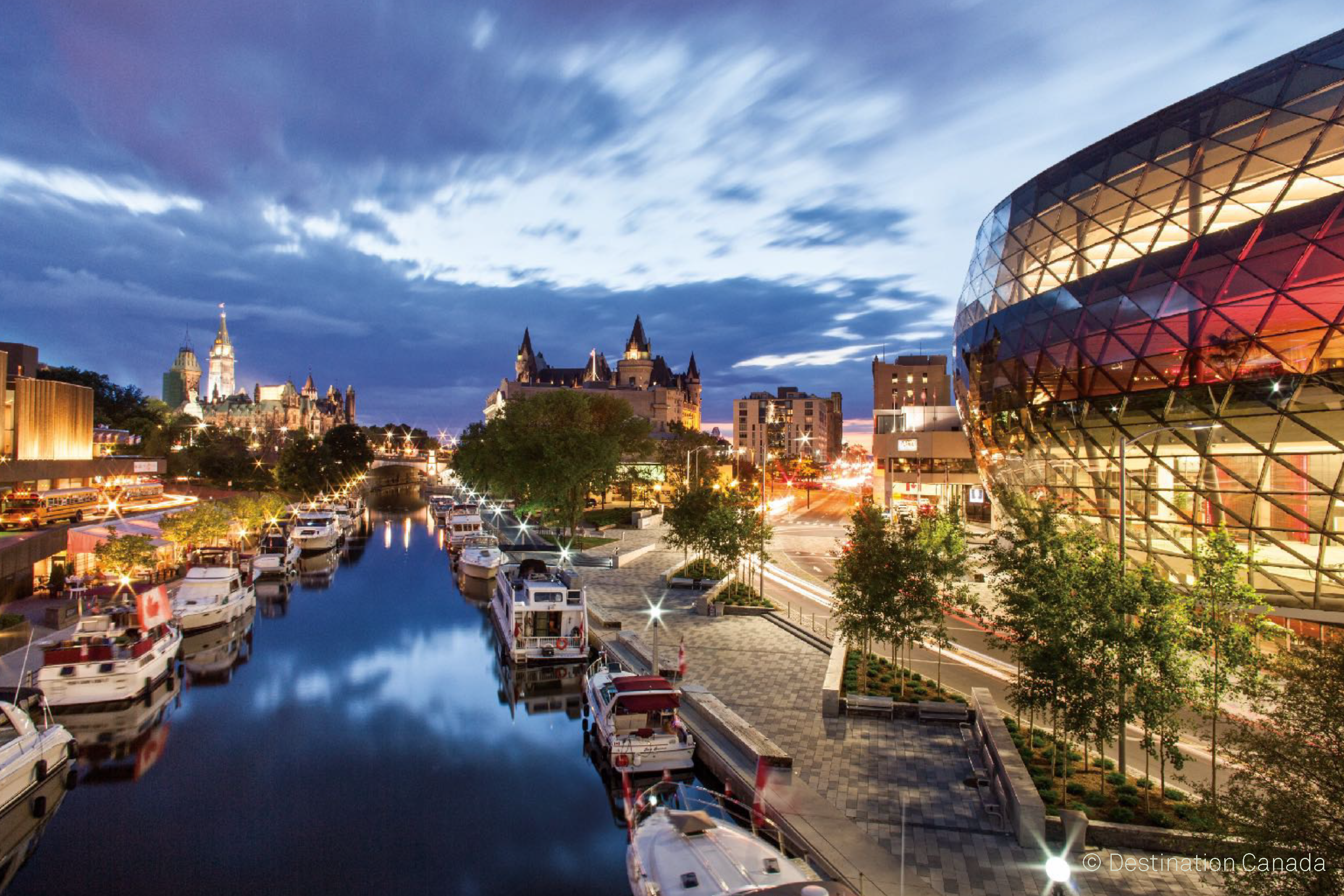 Destination Ottawa image of Ottawa cityscape and harbour at night with boats