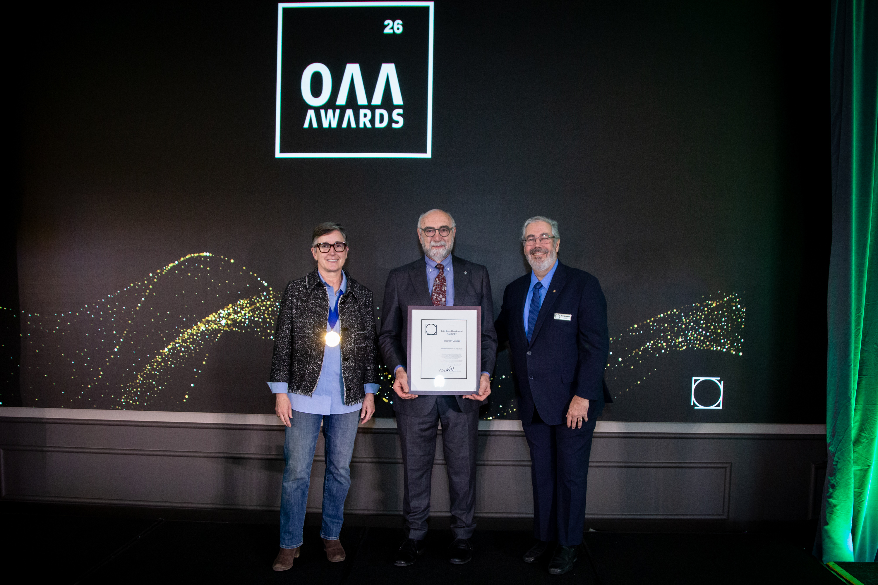OAA President Lara McKendrick and OAA Councillor Bill Birdsell present the Honour Roll Award to recipient Rick Haldenby.