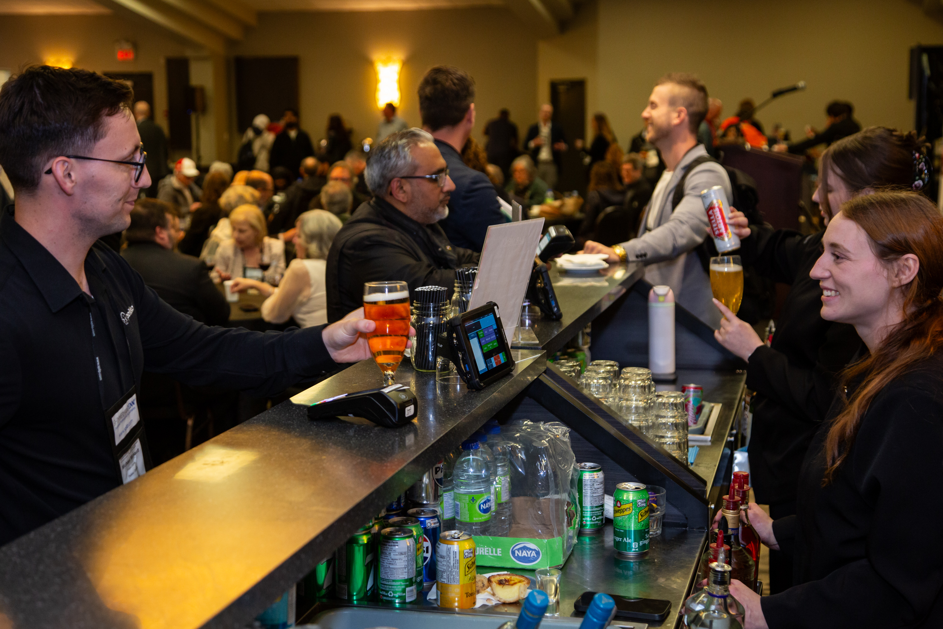 Crowd shot of delegates socializing and drinking