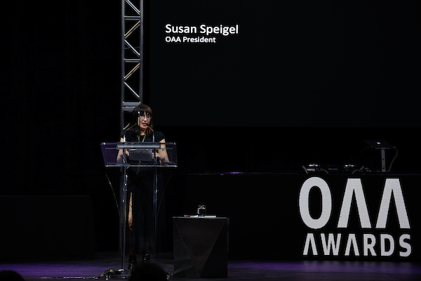 Image of OAA President at the podium on stage