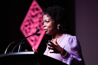 image of Camille Mitchell making a speech at the podium