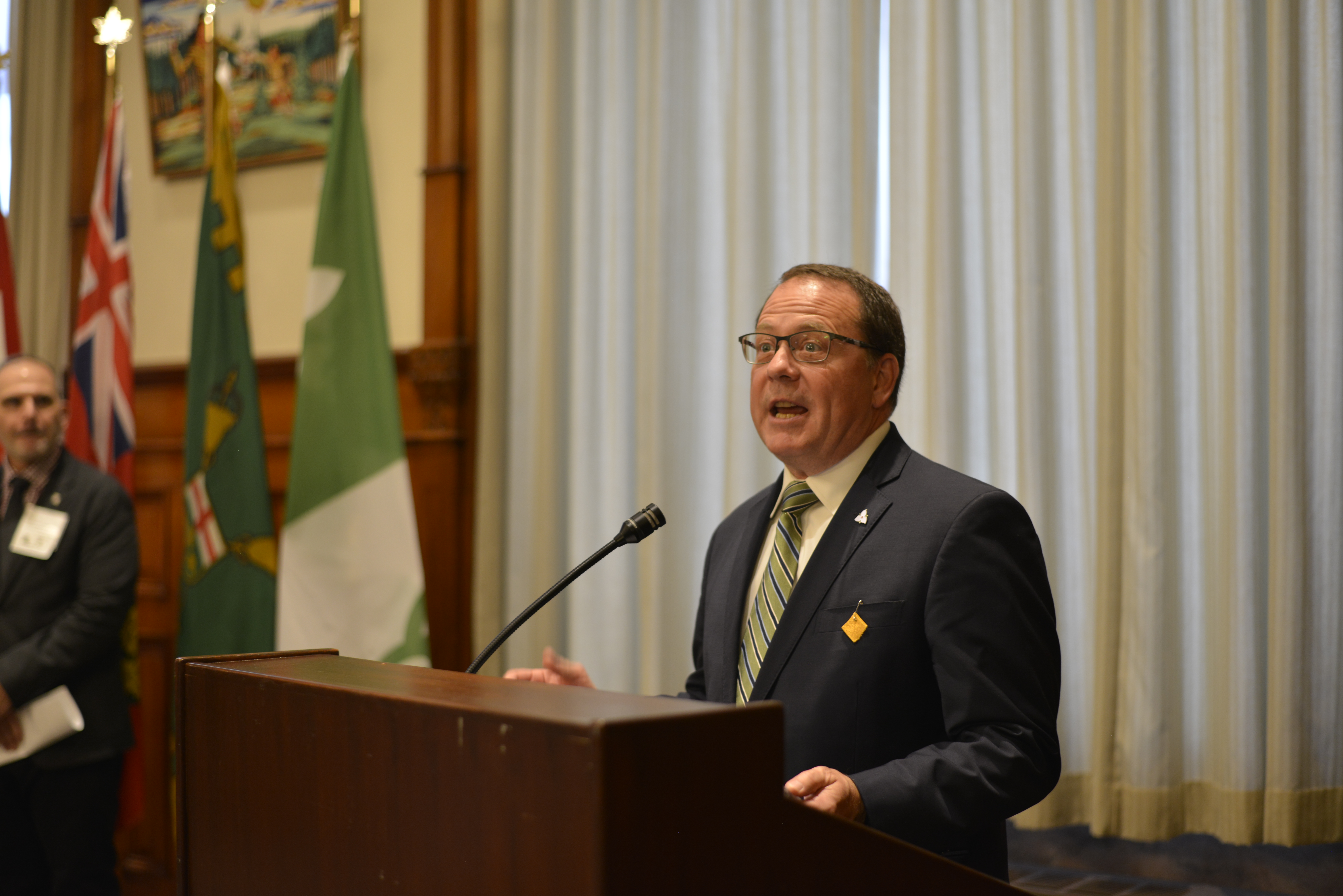 MPP Mike Schreiner (Guelph), leader of the Green Party of Ontario, at the podium for the OAA event at Queen’s Park.
