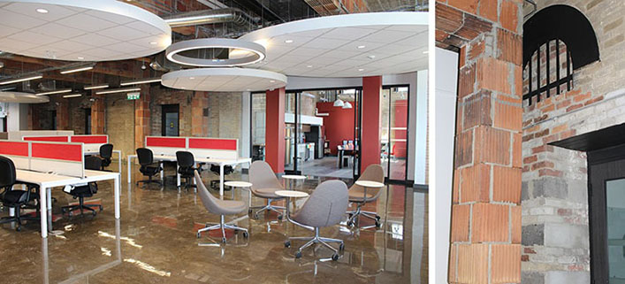 Left: Large office space with exposed brick walls and round acoustic panels hanging from the ceiling. Right: View of terracotta brick column beside a limestone brick wall. 