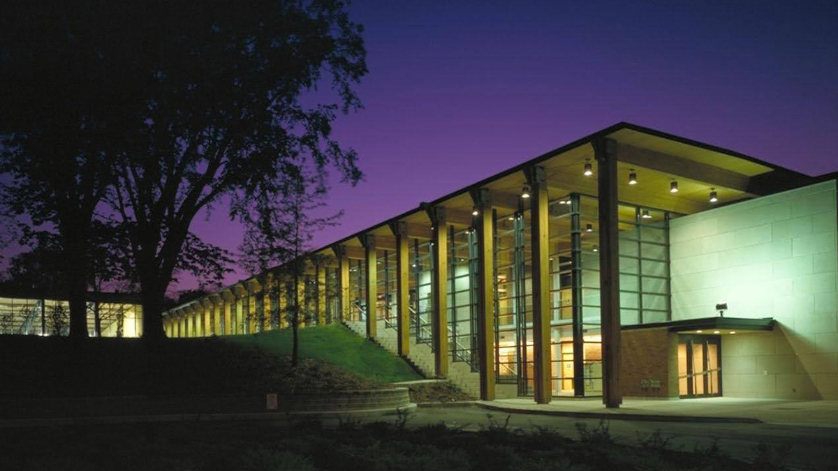 An exterior staircase next to a glass building in dusk light
