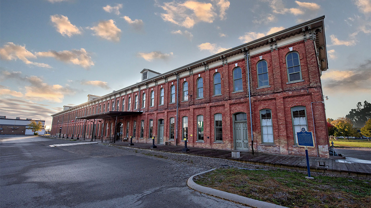 View of the CASO station showcasing its length and size, with red brick walls, arched windows, and a historic architectural style.