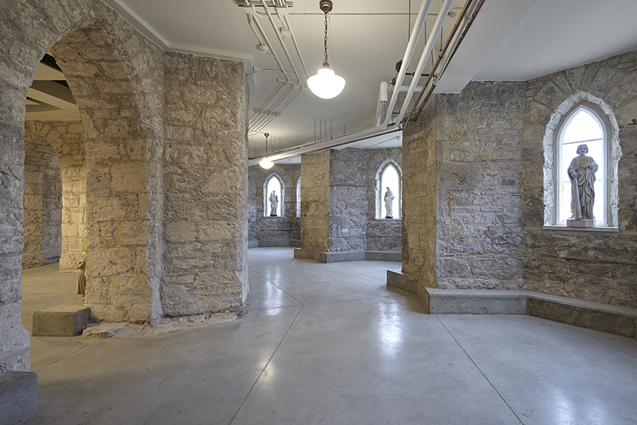 Original stone foundation walls uncovered in the basement, revealing the historic structure's roots.