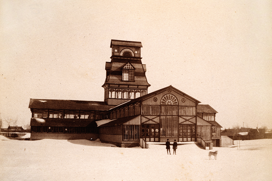 Historic photograph of Kingston's Crystal Palace, featuring intricate Victorian architecture, a central tower, and snow-covered surroundings.