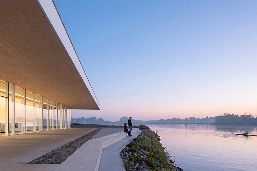 New concrete steps connect the rowing centre to the water, with a serene waterfront view.
