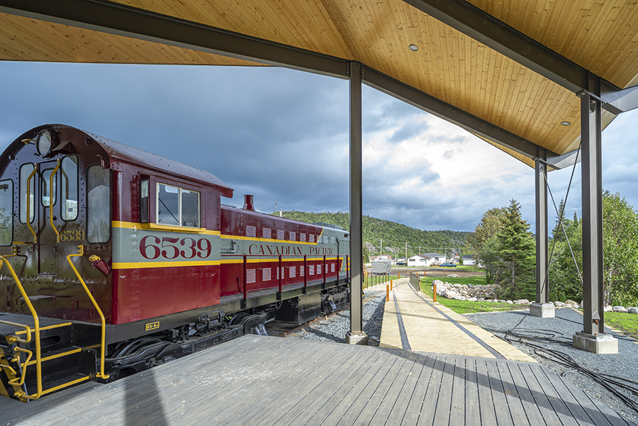 Interior of the Schreiber Discovery Centre, highlighting its wooden beams, steel supports, and railway-themed design elements.