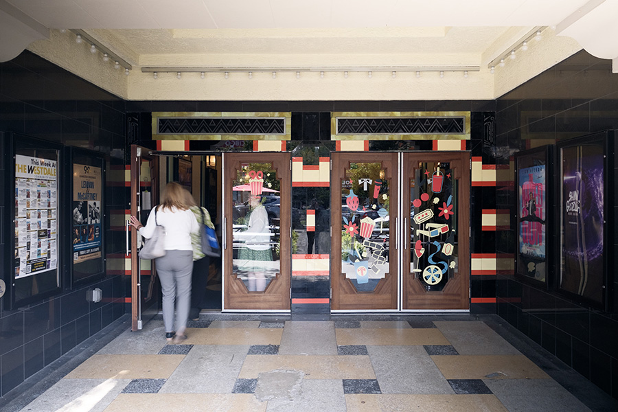 Entrance to the Westdale Theatre, highlighting the original tilework uncovered during its restoration, framed by the theatre's classic architectural details.